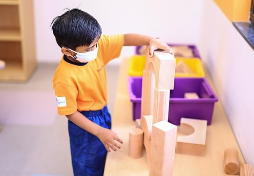 student doing craft activity in a classroom